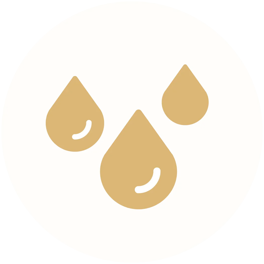 moisturizing icon with three gold water droplets on a light background
